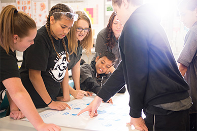 Students in a classroom looking at a diagram