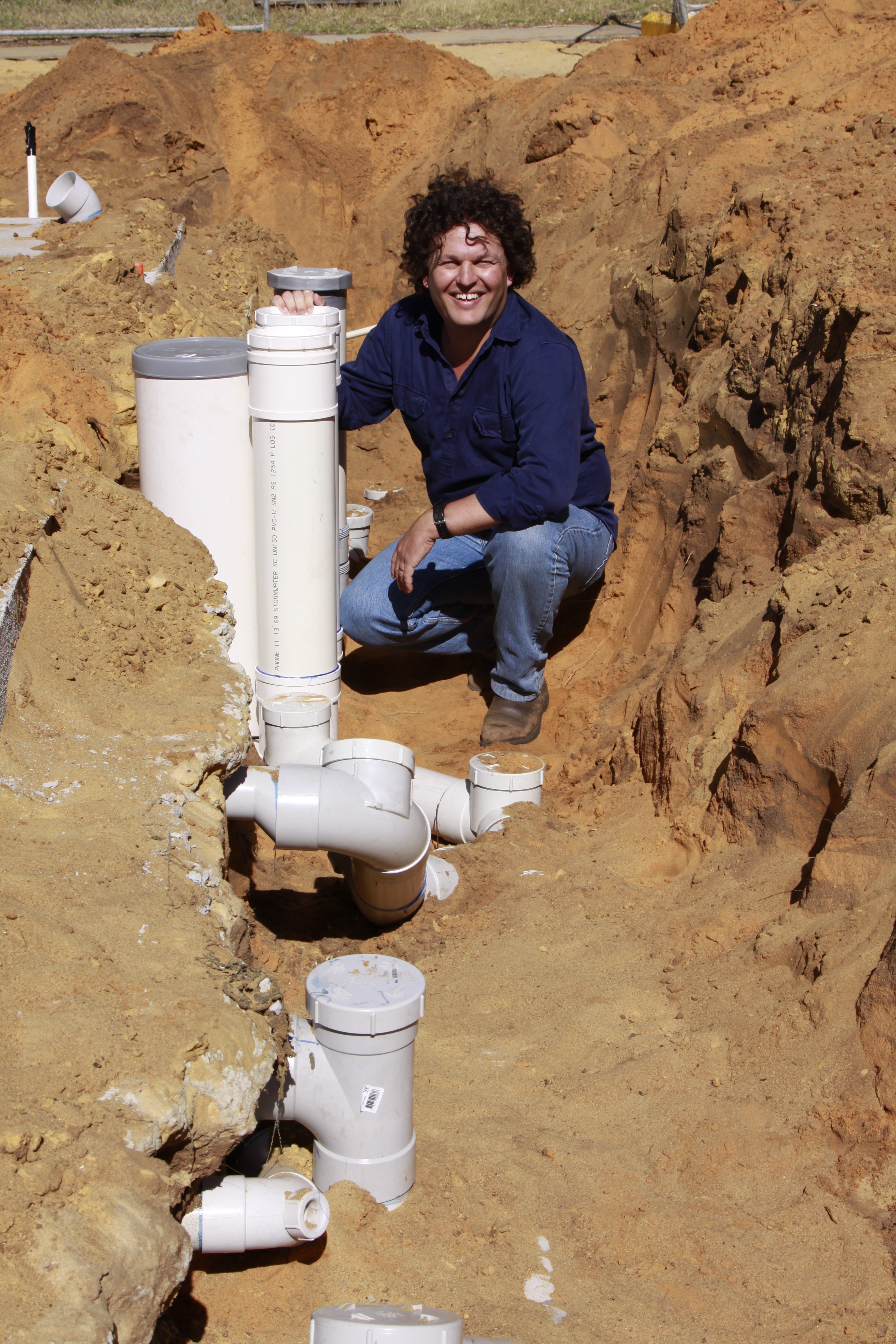 Josh Byrne installing a greywater diversion system